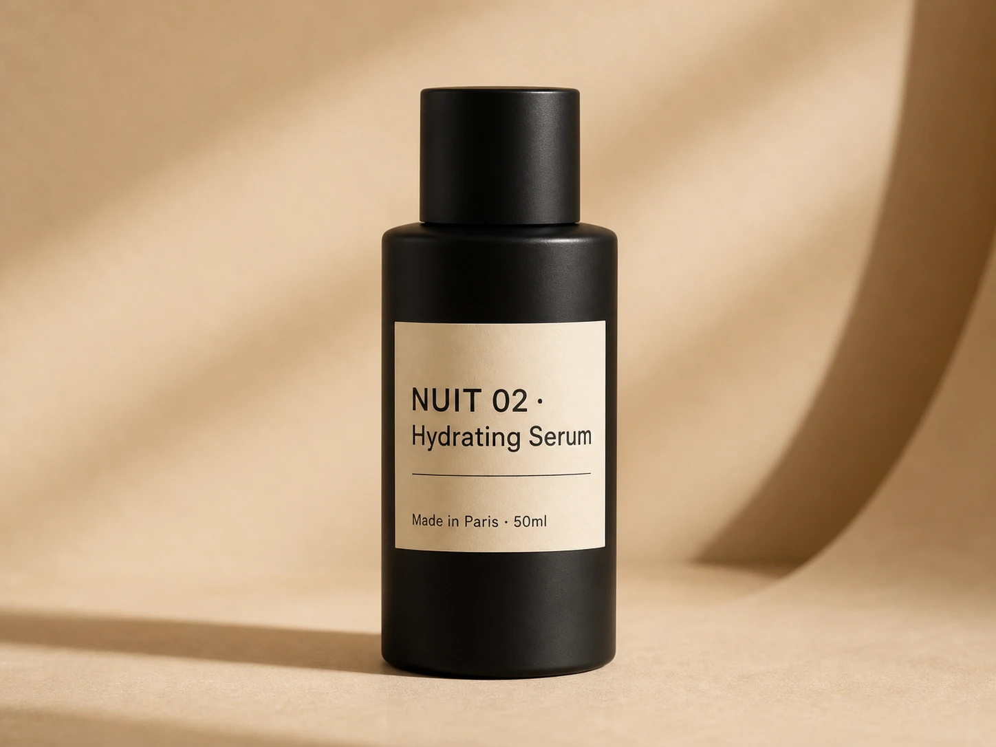 Matte black skincare bottle, the label reads 'NUIT 02 · Hydrating Serum'.